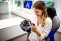 Portrait of woman using virtual reality headset at exhibition show. VR technology simulation concept