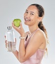 Portrait, woman and water bottle with apple in studio for diet of healthy food, nutrition and detox for weightloss Royalty Free Stock Photo