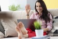 Woman wave hello, talk to friend via video call, happy to hear you Royalty Free Stock Photo