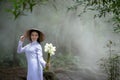 Portrait woman wearing Ao Dai Vietnam traditional dress holding Royalty Free Stock Photo