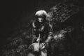 Portrait of a woman wearing fur hat and fox fur pelt on her shoulders.Playing shamanic drum.Shot in forest surroundings. Royalty Free Stock Photo