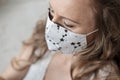 Portrait of woman wearing handmade cotton fabric face mask. Protection against saliva, cough, dust, pollution, virus, bacteria,
