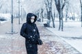 Portrait of a woman wearing a medical protective mask on her face in winter, Covid-19 coronavirus pandemic, virus protection