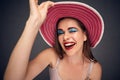 Portrait of woman wearing red summer hat.