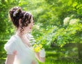 Portrait woman in a white dress with a hairstyle of bride in park Royalty Free Stock Photo