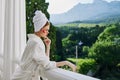 Portrait woman in a white robe the balcony overlooks the mountains unaltered