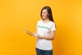 Portrait of woman in white t-shirt with written inscription green title volunteer using tablet pc computer isolated on