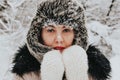 Portrait of a woman in a winter landscape. A cold woman. Winter walk