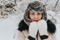 Portrait of a woman in a winter landscape. A cold woman. Winter walk