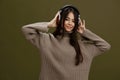 portrait woman wireless headphones music fun technology Green background Royalty Free Stock Photo