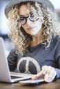 Portrait of woman working with computer in a cafe or airport gate station. Digital nomad and modern worker. Female people using Royalty Free Stock Photo