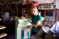 Portrait Of Woman In Workshop Upcycling And Working On Fire Surround