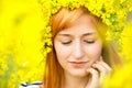 Portrait of woman with wreath of yellow flowers on the head