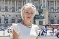 Portrait of a woman 60-65 years old in summer against a blurred background of ancient architecture of the Austrian city of Vienna Royalty Free Stock Photo