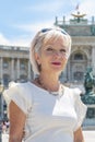 Portrait of a woman 60-65 years old in summer against a blurred background of ancient architecture of the Austrian city of Vienna Royalty Free Stock Photo