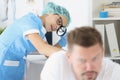 Woman dermatologist examine male patient body, check skin on back with magnifying glass