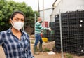 Portrait of woman farmer wearing protective mask in the backyard of house Royalty Free Stock Photo