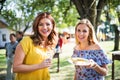 Portrait of two women on a family celebration or a barbecue party outside in the backyard.