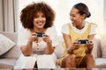 Portrait of women on sofa playing video game, excited fun and relax in home living room together on internet. Online