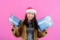 portrait, Women wear thick fabrics keep their bodies warm wearing Christmas hat, was smiling happily as received gift holding two Royalty Free Stock Photo