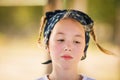 The portrait of wondered blonde girl with two braids