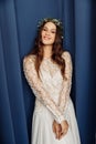 Portrait of wonderful young bride with long hair on blue background Royalty Free Stock Photo