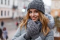 Portrait of a wonderful young woman with beautiful blue eyes with natural make-up in a sweet smile in a knitted hat Royalty Free Stock Photo