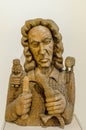 A portrait of a wood carver is carved out of wood