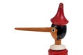 Portrait of wooden Pinocchio puppet with his big nose close up on white background
