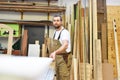 Portrait of a worker in a joinery at the workplace - woodworking