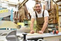 Portrait of a worker in a joinery at the workplace - woodworking