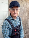 Portrait of a worker in overalls and protective glasses in a room during repairs Royalty Free Stock Photo