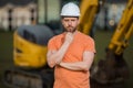 Portrait of worker small business owner. Construction worker with hardhat helmet on construction site. Construction