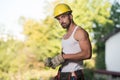 Portrait Of A Worker Takes Off The Gloves