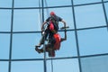 worker washing windows of the modern building