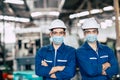 Portrait worker wearing face shield or disposable face mask during working service team in factory to prevent CoronavirusCovid-19