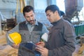 Portrait workers during conversation in factory