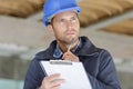 portrait workman preparing estimate for work on house