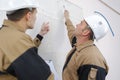 portrait workmen examining wall Royalty Free Stock Photo