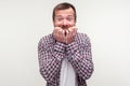 Portrait of worried bearded man looking scared nervous biting his nails, psychological problems. studio shot, white background