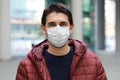 Portrait of worried man in modern city street wearing protective face mask Royalty Free Stock Photo