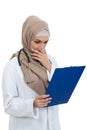 Portrait of worried muslim female Medical doctor holding paperclip isolated