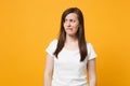 Portrait of worried nervous young woman in white casual clothes looking aside, biting lips isolated on bright yellow Royalty Free Stock Photo