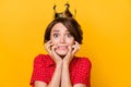 Portrait of worried puzzled girl biting fingers nail staring camera terrified face isolated on yellow color background