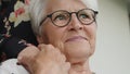 Portrait of worried senior lady cuddling hand of a young lady on her shoulder Royalty Free Stock Photo