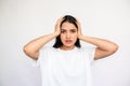 Portrait of worried young woman holding head in hands Royalty Free Stock Photo