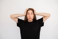 Portrait of worried young woman holding head in hands Royalty Free Stock Photo