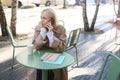 Portrait of worried young woman, sitting in cafe outdoors, calling someone with stressed, concerned face, anxiously Royalty Free Stock Photo