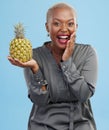 Portrait, wow and black woman pineapple in studio for detox, lose weight or diet nutrition on blue background. Fruit