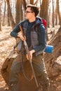 Portrait of yang hunter with a backpack and a gun on the forest